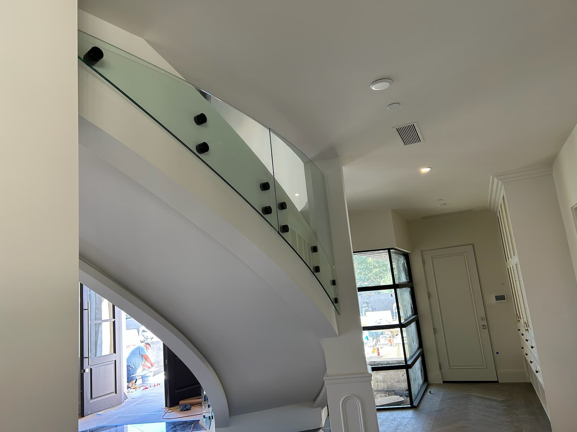 Curved glass railing on spiral staircase