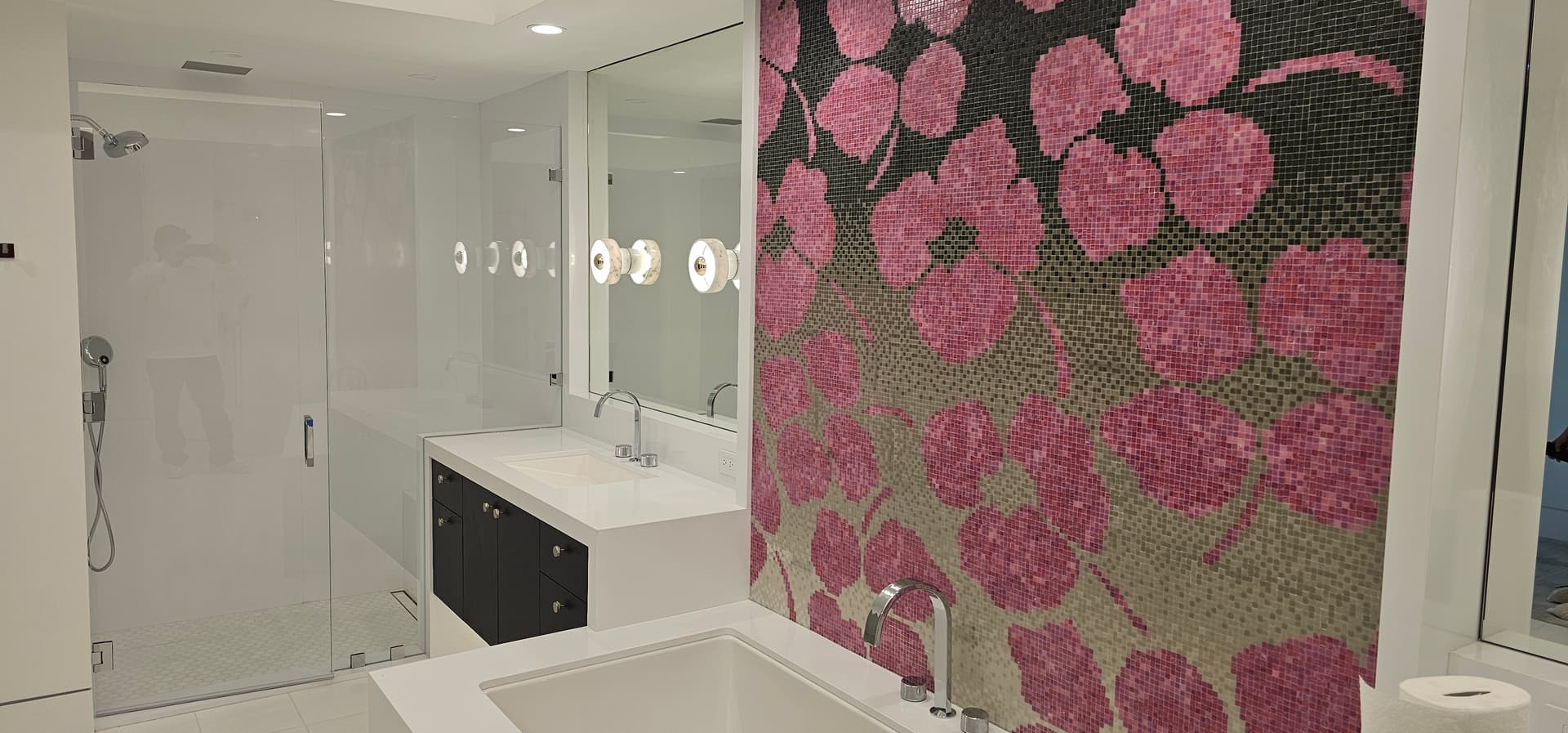 Frameless shower enclosure with pink mosaic feature wall